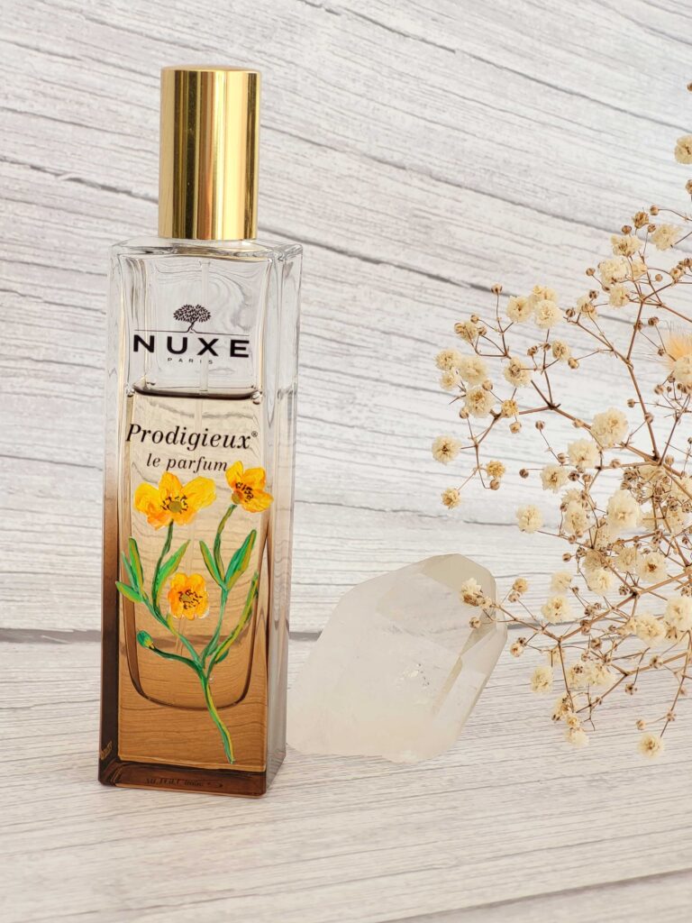painted bottle of perfume Nuxe