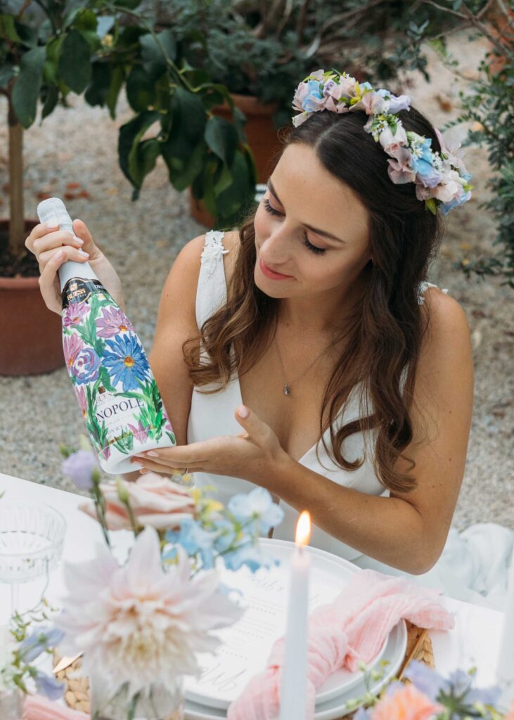 Bride holding a painted wine bottle